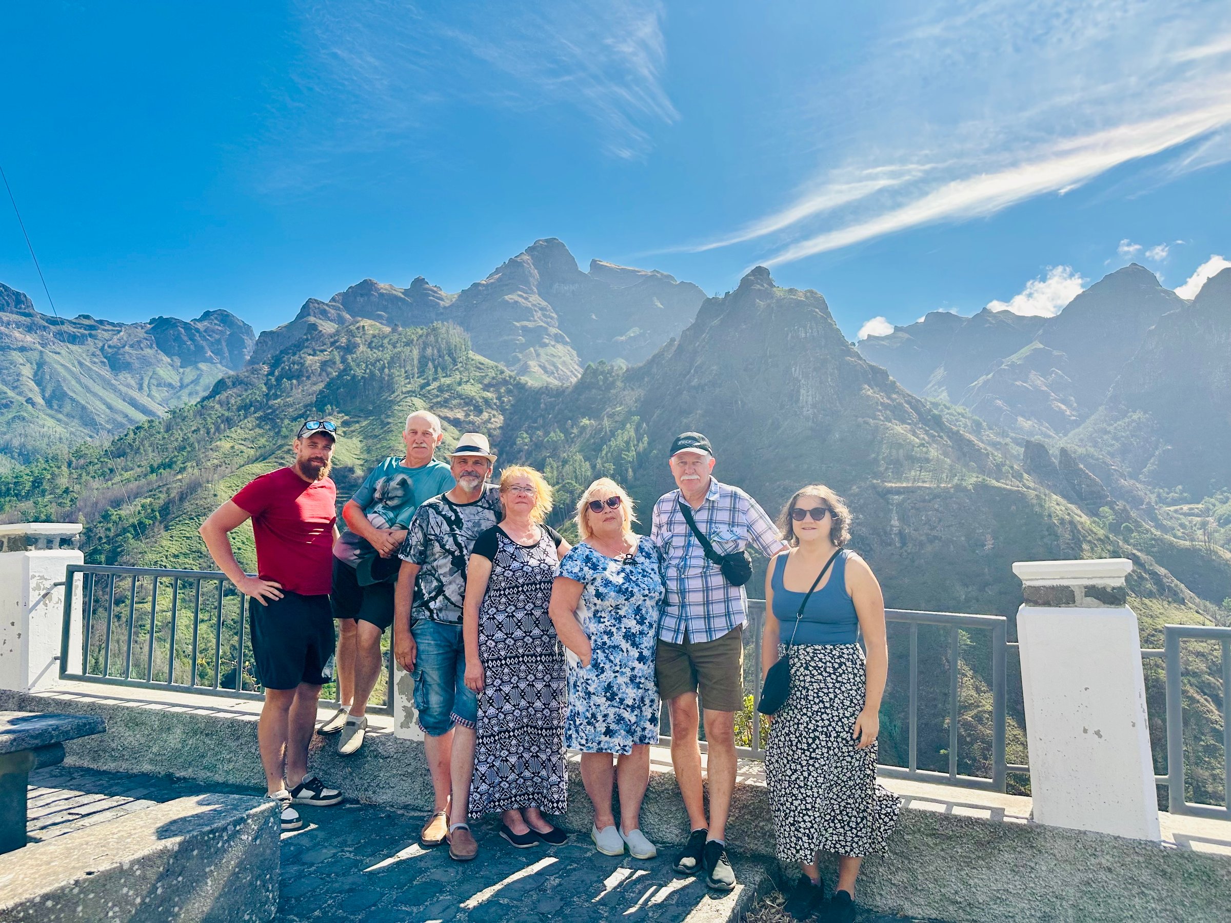 Group at mountain viewpoint with dramatic peaks